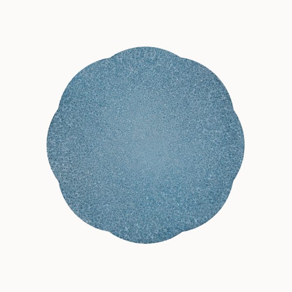 Against a white background, blue and brown scalloped orb is made of tiny dots. Towards the center of the circle, dots become smaller and denser, creating the appearance of a solid blue color.