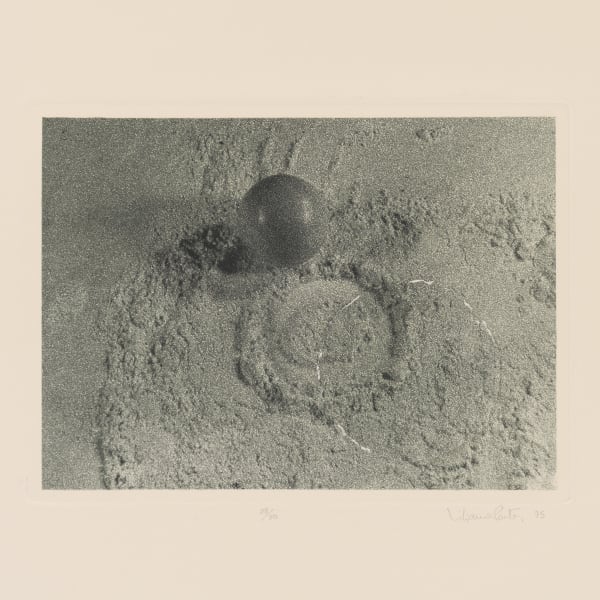 Print with white border of sand with sphere, circle cut into sand, and cut circle matching print.