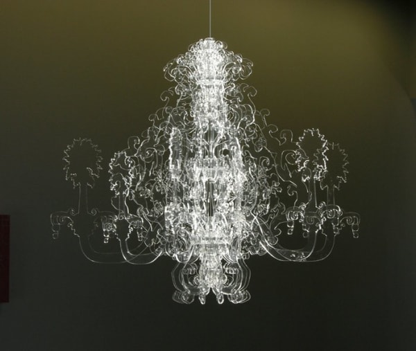 Clear sheets of plexiglass laser cut in intricate patterns are slotted together to form a hanging ornament reminiscent of a chandelier
