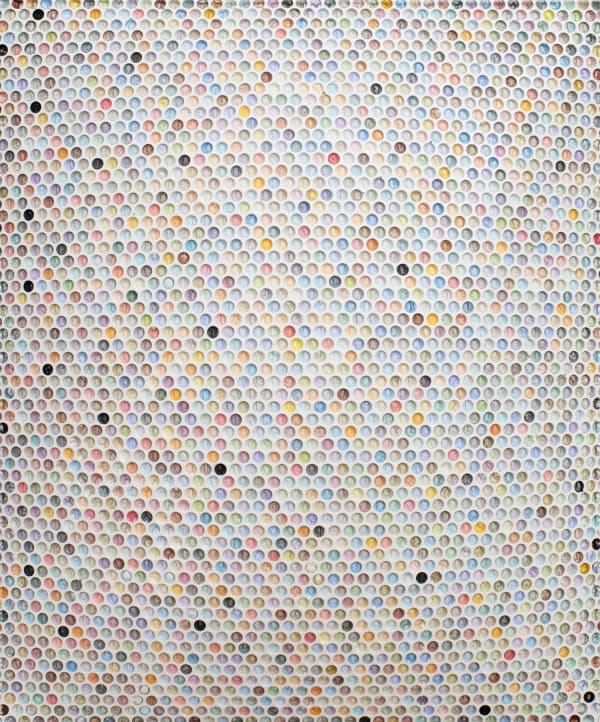 bubble wrap indents cast into plaster and painted in various pastel colors with a few ones done randomly in black