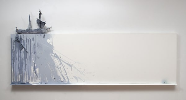 Blue and gray splashes of paint dash and drip down the left side edges and surface of a rectangular white canvas. A two mast ship is mounted on the top edge of the piece above the paint. All the way to the far right a tiny human figurine is surrounded by blue paint spray and had its head between his knees