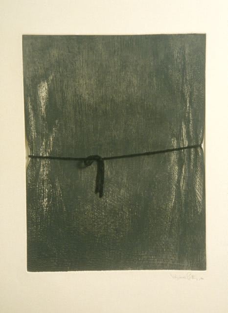 Dark green etching with black string of yarn. The yarn is placed over two areas of the etching where there appear to be horizontal indentations creating the illusion that the yarn being wrapped around the green etching