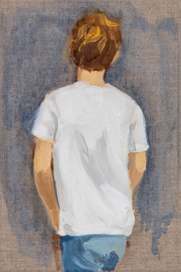 Boy in white t-shirt with hand in pocket faces away from viewer in front of blue and exposed canvas background. His legs are cropped out of the composition.