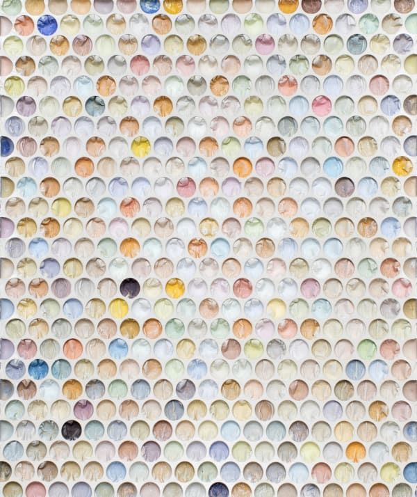 bubble wrap indents cast into plaster and painted in various pastel colors with a few ones done randomly in black