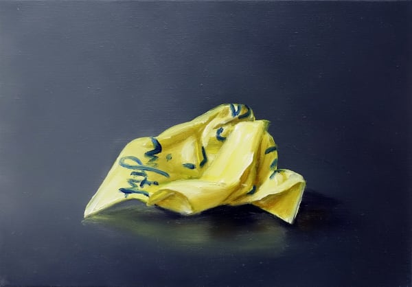 One crumpled yellow Post-it note with blue cursive writing against dark gray background.