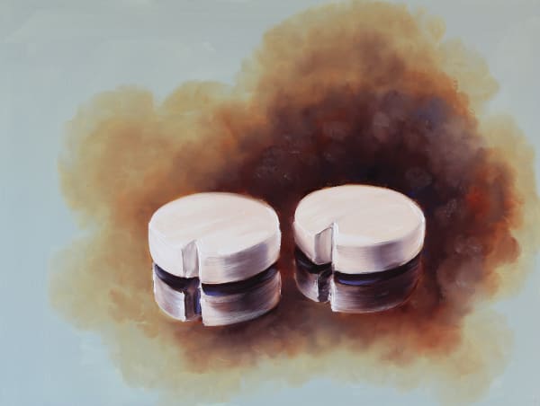 Two circular pieces of wood with small triangular cut-outs casting their reflections against cloudy brown background.