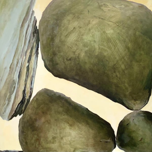 An image of medium large gray boulders with a light yellow sky background.