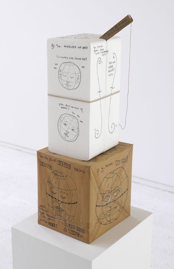 An image of boxes stacked up with drawings all over.