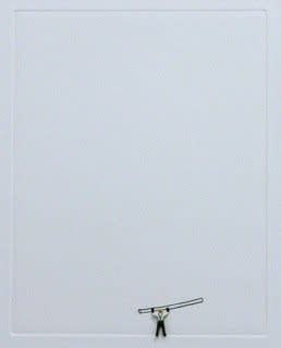 Solar etching of an item that looks like a large bobby pin at the lower right of a white piece of paper. Directly beneath the etching a tiny human figurine appears to be holding the large bobby pin over its head