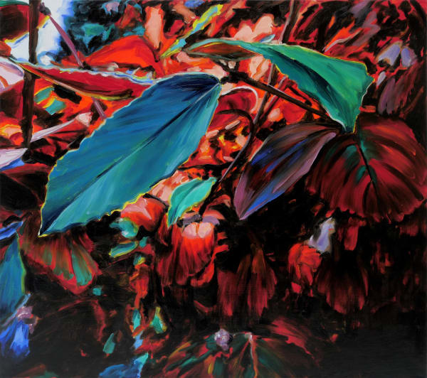 Large green leaves emerge towards the viewer from background of dense red foliage.