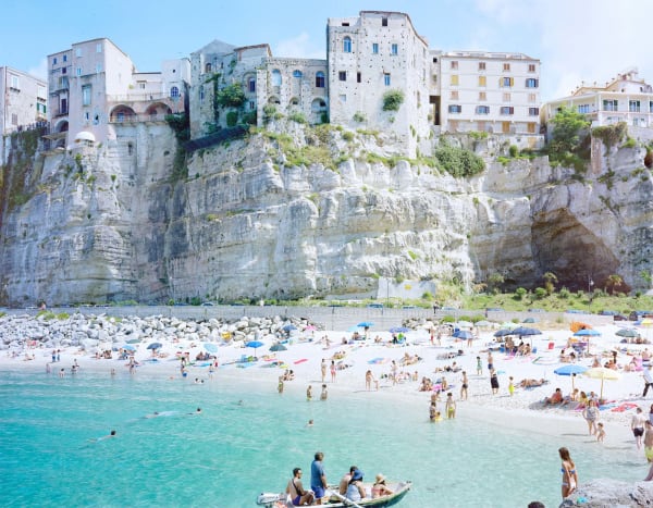 View of Tropea beachside with boat in ocean, made in Calabria Italy, by Massimo Vitali