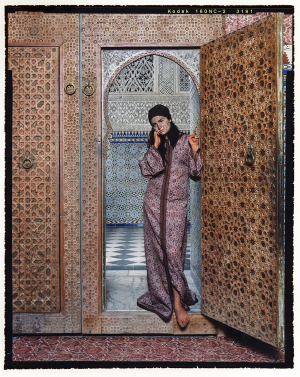Woman standing in arched doorway of Moroccan palace, from Harem series by Lalla Essaydi
