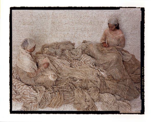 Lalla Essaydi Les Femmes du Maroc two women inscribing henna onto large pile of fabric