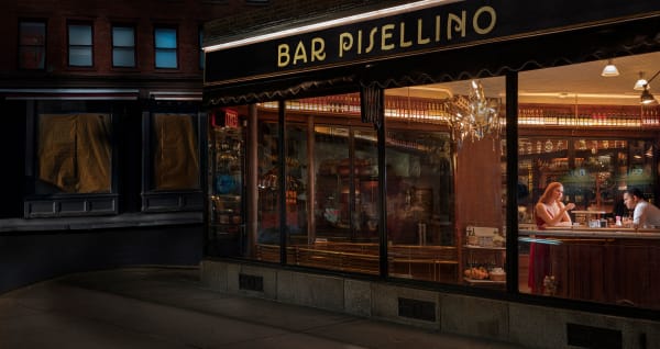 Bar Pisellino in New York at night with woman and bartender inside, from Gail Albert Halaban's Out My Window series