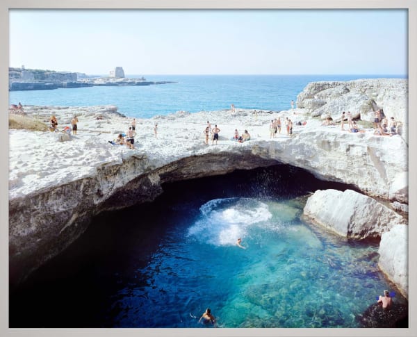 Beachgoers sunbathing at grotto Poesia Tuffo, Italy by Massimo Vitali