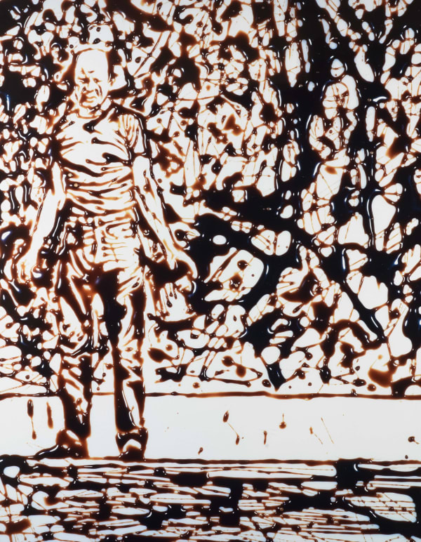 Vik Muniz photograph of Jackson Pollock standing in front of action painting rendered in chocolate syrup against white background