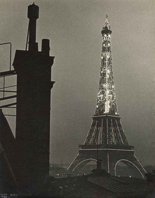 Ilse Bing photograph of Eiffel Tower illuminated at night in Paris