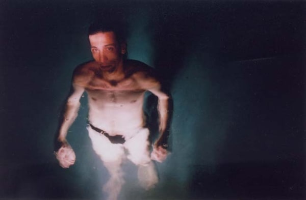 Elinor Carucci Eran's Blaming Eyes man in speedo submerged in water body foreshortened