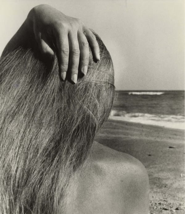 woman with hand on head on beach at Taxo d'Aval France by Bill Brandt
