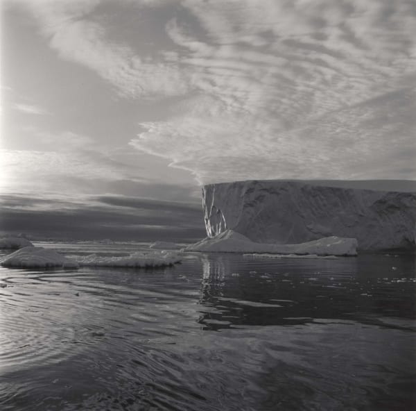 Lynn Davis photograph of Iceberg in Disko Bay, Greenland against swirling clouds and swirling water