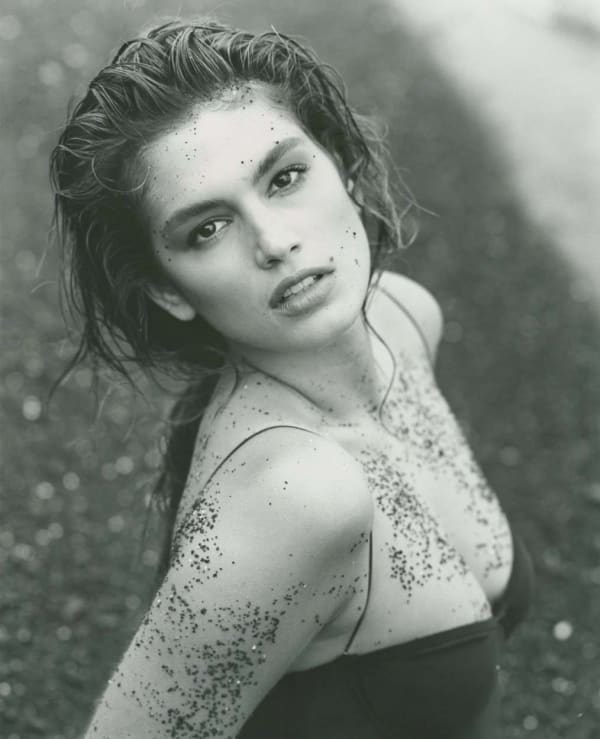 Herb Ritts photograph of Cindy Crawford in bathing suit with black sand, Hawaii