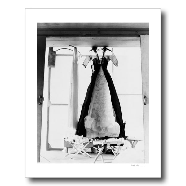 Milton H. Greene, An elegant woman’s dress is hung up next to a window