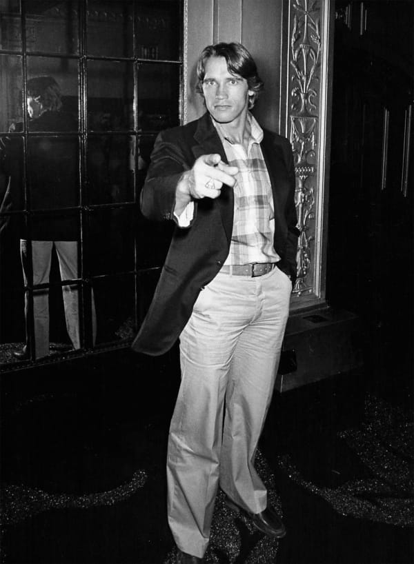 Ron Galella, Arnold Schwarzenegger pauses and recognizes Ron Galella, Coty Awards party at Studio 54, September 28, 1978