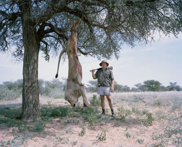 David Chancellor, Untitled Professional Hunter with Trophy Lion, Kalahari, Northern Cape, South Africa