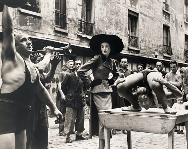 Richard Avedon Elise Daniels with Street Performers, Suit by Balenciaga, Le Marais, Paris, 1948