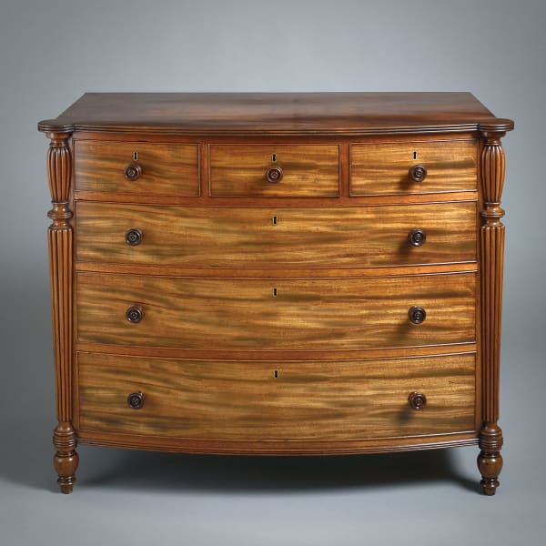 REGENCY FIGURED MAHOGANY BOW-FRONT CHEST BY GILLOWS