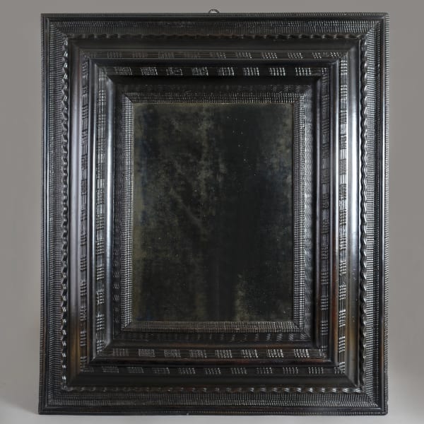 NORTH ITALIAN EBONISED RIPPLE-MOULDED MIRROR