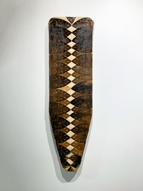 Willie Cole Domestic Shield XX, 2020 Iron scorches on canvas with resin and wax mounted on wood 54 x 16 x 3 in. 137.2 x 40.6 x 7.6 cm