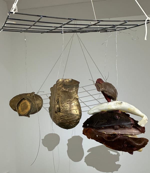 Bruce Nauman, 2 bronze heads hung with bundled damaged or packrat chewn wax fish, 2025