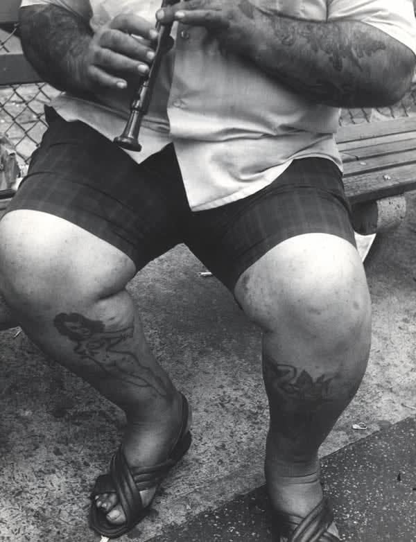 Leon Levinstein, Untitled (Tattooed man playing the flute), c.1960