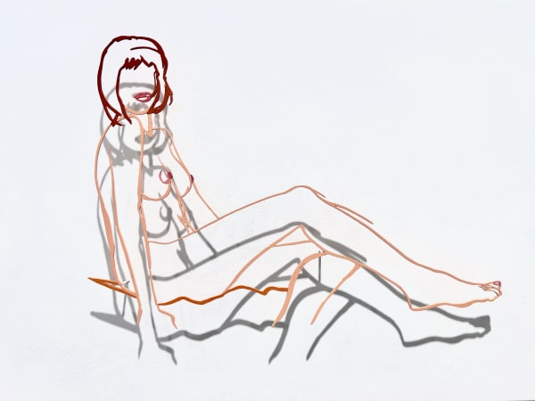 Monica sitting one leg on the other