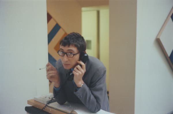 Kasmin Kasmin at his gallery's front desk during the Kenneth Noland show, 1965 C-type colour print Signed and numbered verso Standard, image: 18.9 x 28 cm (7 1/2 x 11 in), from the edition of 25 Large, image: 24.3 x 37.5 cm (9 5/8 x 14 3/4 in), from the edition of 10
