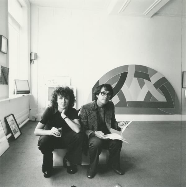 Kasmin Lindy and Sheridan Dufferin in the Kasmin Gallery; behind them a Frank Stella painting, Clifford Street, London, c. 1975 Black & White fibre print Signed and numbered verso Standard, image: 21.4 x 27 cm (8 3/8 x 10 5/8 in), from an edition of 25