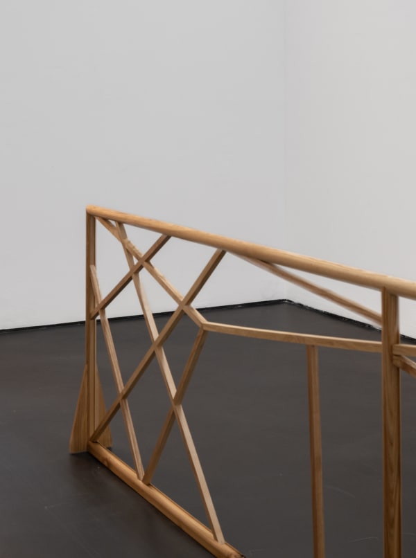 Partial view of wooden railing structure with vertical and horizontal wooden balance beams running through it. Rindon Johnson Fruit of the poisonous tree, Higher and more free! The music must always play, All the conventions conspire to make this fort assume the furniture of home; Lest we should see where we are, higher and more free! Lost in a haunted wood, What are the consequences of two different forms interacting? Ice on a bed of mint leaves. That’s what I thought in the early morning. Higher and more free! Breeze engine. If no is what it is then that’s what it is. Breeze Engine. Paint dries on walls. Bells chime at noon. Rivers flow through canyons. Enough. Enough. Enough. Enough. Enough., 2023 Ash wood 420 x 67.5 x 16.5 cm 165 3/8 x 26 5/8 x 6 1/2 inches