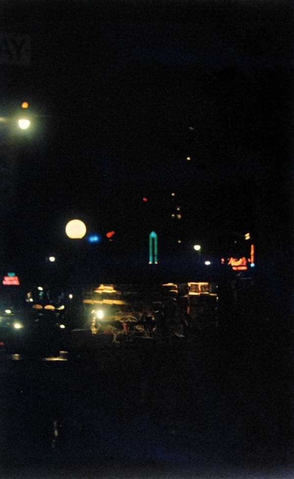 Saul Leiter, Untitled (newsstand with colored lights at night), 1958