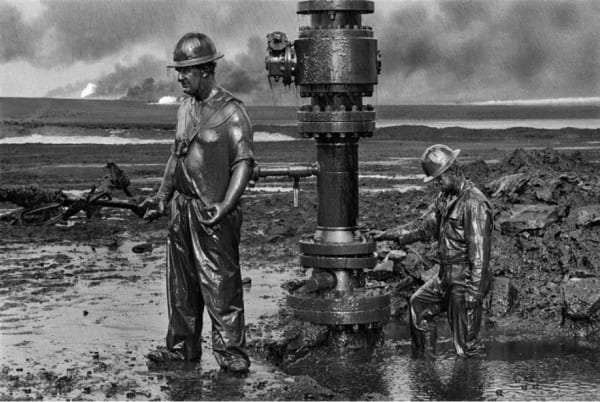 Sebastião Salgado Workers place a new wellhead, Oil Wells, Kuwait, 1991 gelatin silver print 24 x 35 in.