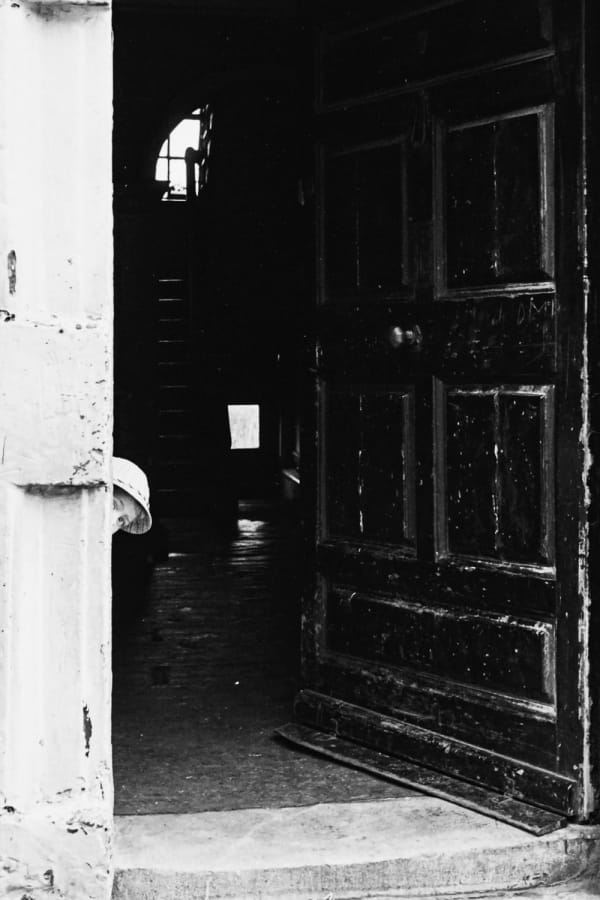 Edward Quinn, Boy peeking our of door frame, Dublin, 1963