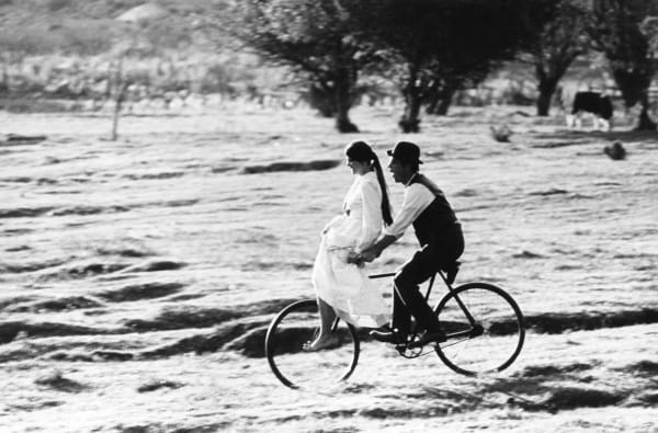 Lawrence Schiller, Paul Newman riding a bicycle with Katherine Ross sitting on the handle bars; during the production of Butch Cassidy and the Sundance Kid, Mexico, 1968