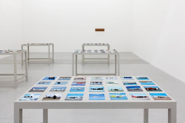 Runo Lagomarsino OtherWhere, 2011 168 postcards and stones, 6 painted wood tables