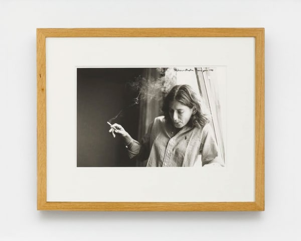 Ed Templeton Elissa smokes near window, Prague, Czech Republic, 1999, 2008 Black and white photograph with text