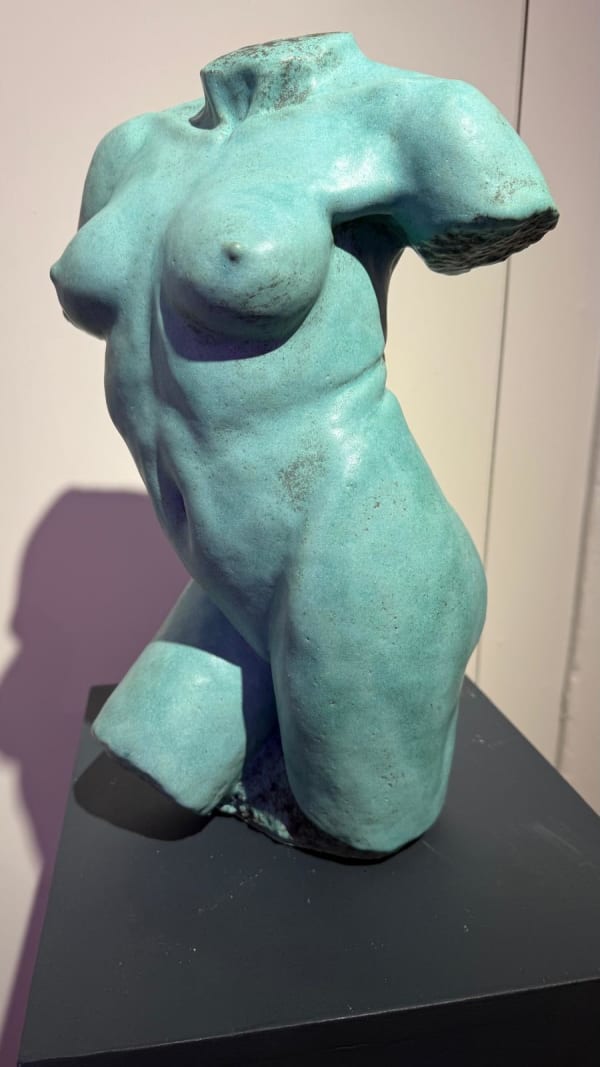 Green sculpture of female body