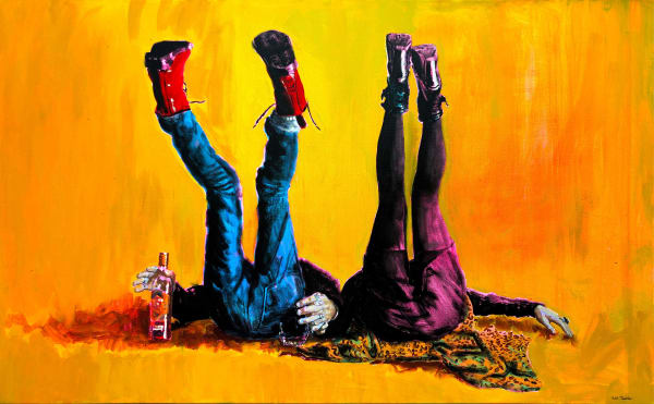 Couple lying with their backs on the floor and legs in the air holding a bottle on yellow background