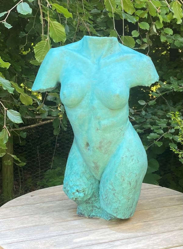 Green sculpture of female body