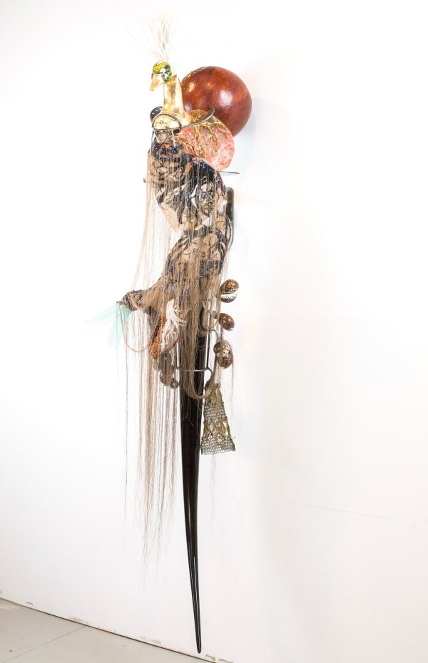 Rina Banerjee See her beak a coppery bill, her pointed puncture with black horn waiting in edges of river among stones and ocean pearls, her coarse curls sleeps outside of home, outside of culture, in open air, feel her tire without tone of muscle in effortless slumber, 2017 Glass, steel, silk, ceramic, plastic net, shells 195 x 55 x 43 cm
