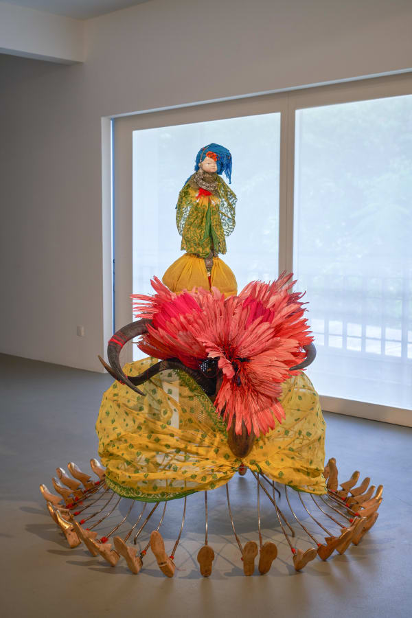 Rina Banerjee Preternatural passage came from wet whiteness and mercantile madness, paid for circular migrations, she went thirty six directions that is all the more different, where empire threw her new born and heritage claimed as well, this lady bug was not scarlet , 2011 Steel armature, vintage porcelain baby doll head, wooden spindle, cowrie shells, red thread, vintage birch wood shoe form (size 9-10), Bengali saree, feathers, horns, costume wedding jewelry H164 x W151 x L160 cm