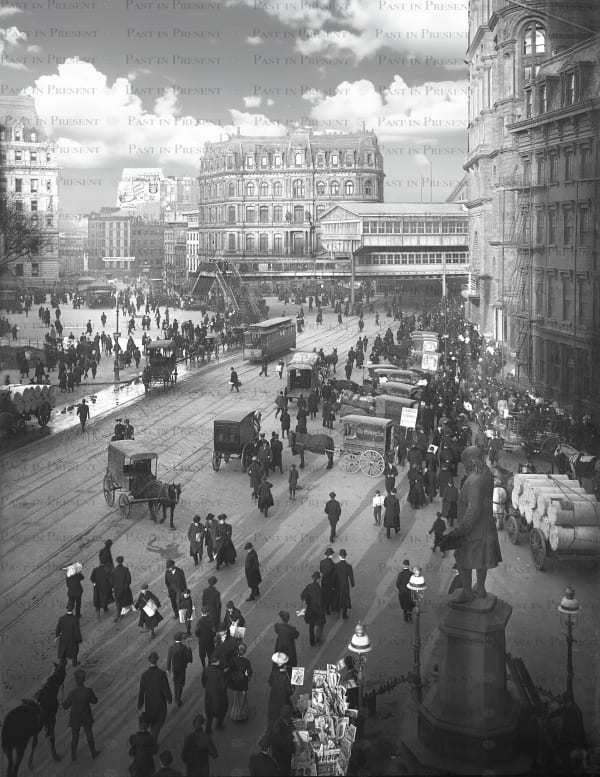 “Rush Hour” NYC street cars, horse-drawn carriages and crowd of evening pedestrians on Park Row are heading in the direction...